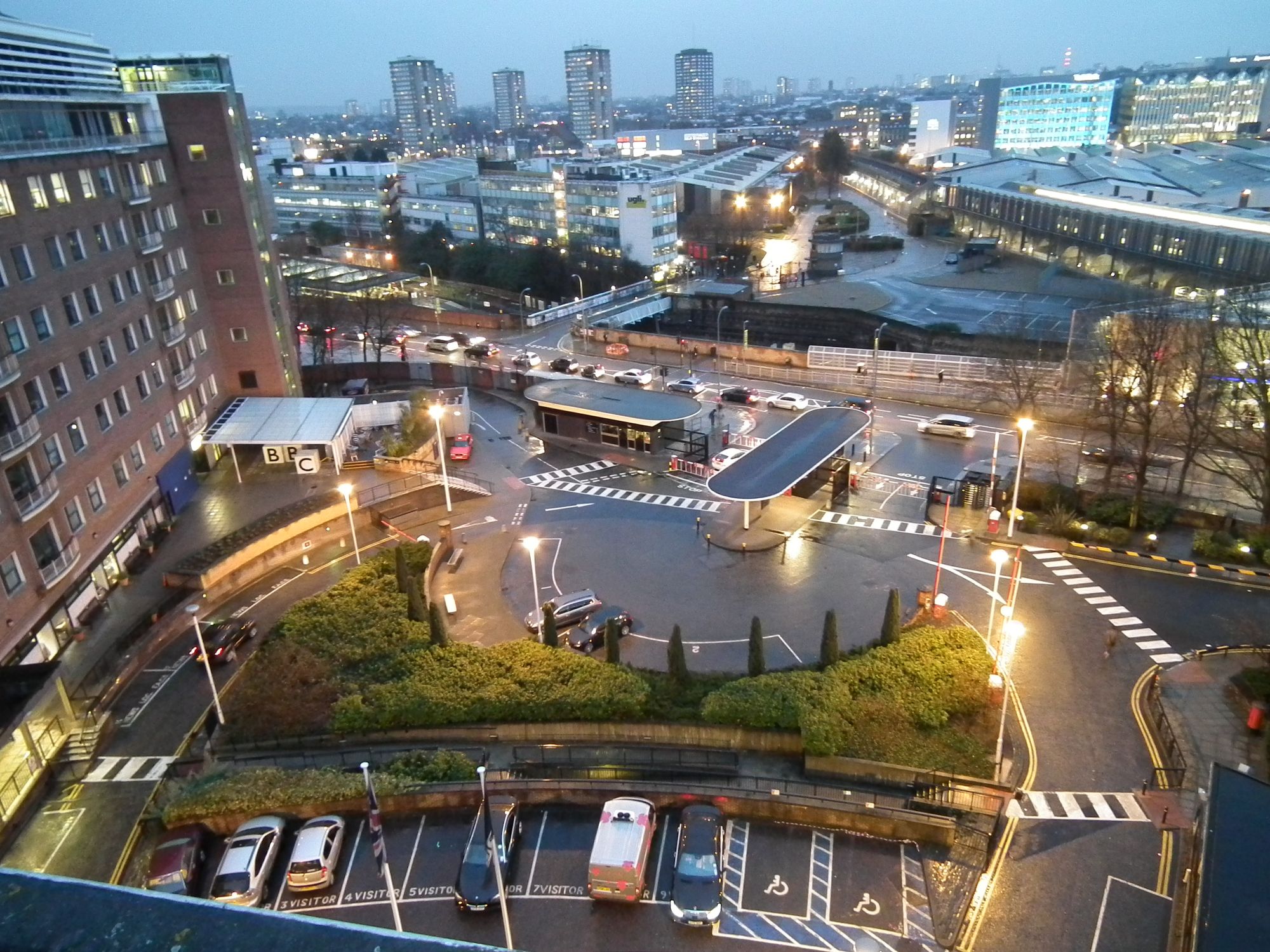 Even though it's a gloomy day, a bright, colourful view of the front area of Television Centre, taken from the top floor of the doughnut.