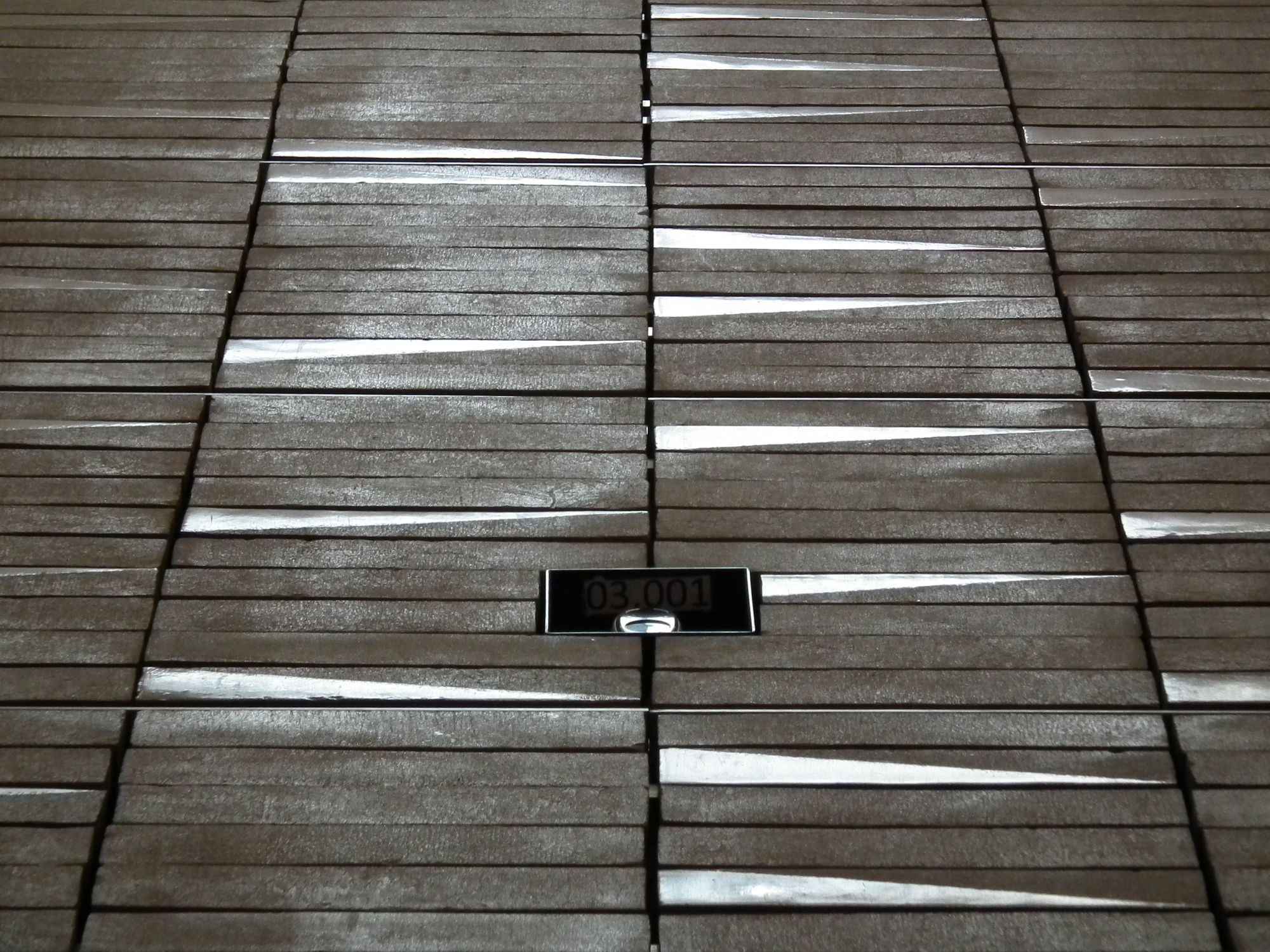 Looking up the end wall. This viewing angles accentuates the fact that some of the tiles have a diagonal, with different textures each side.