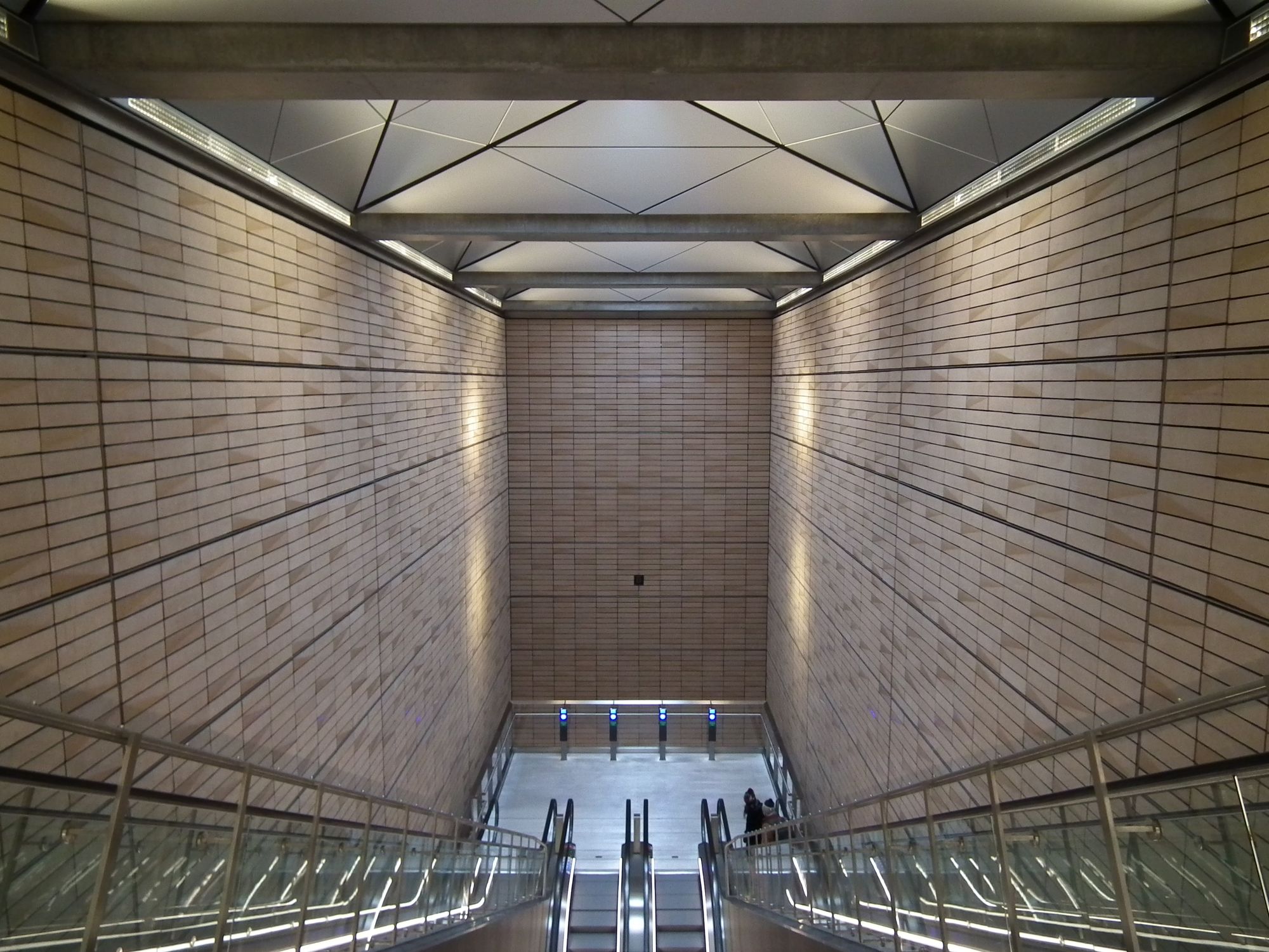 The station well (i.e. the large cuboid space, with the platform area as its base). The walls here are made of (well, covered with) housebrick-sized red-beige tiles.