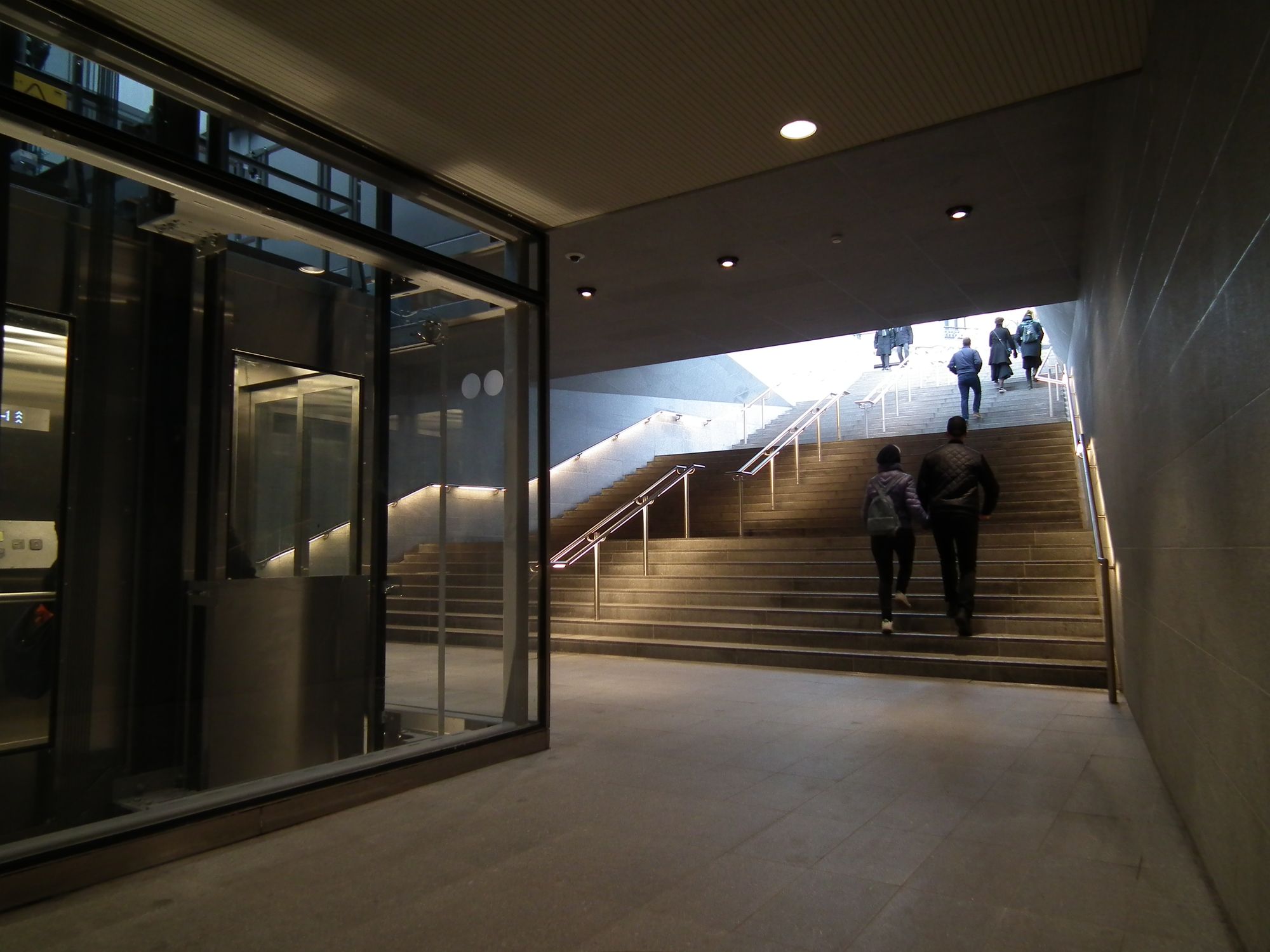 Stairs and a glass elevator to street level