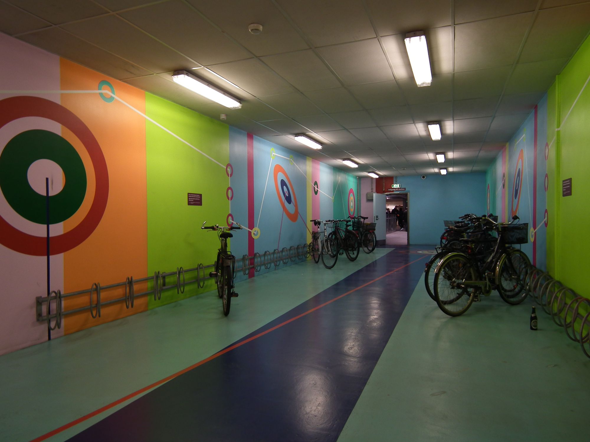 The bike area. Bike racks on the side walls. The colourful artwork continues in this area.